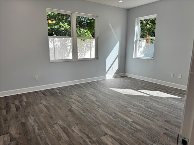 spare room with dark hardwood / wood-style floors