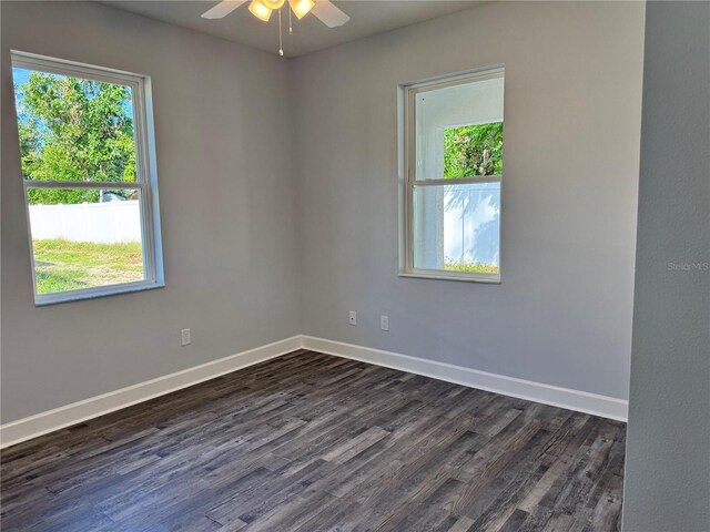 unfurnished room with ceiling fan and dark hardwood / wood-style floors