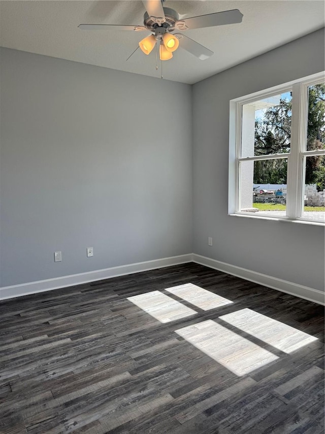 spare room featuring ceiling fan and dark hardwood / wood-style flooring