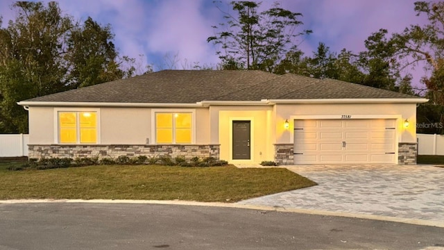 view of front facade featuring a lawn and a garage