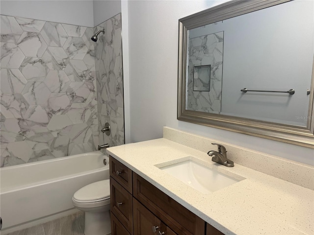 full bathroom featuring vanity, toilet, and tiled shower / bath