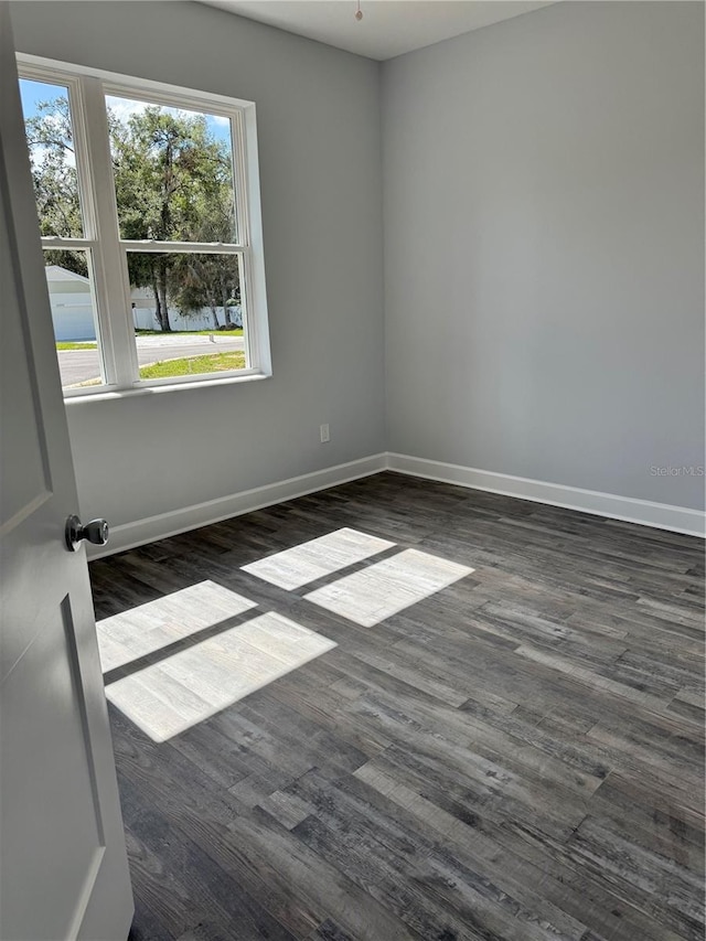 empty room featuring dark wood-type flooring