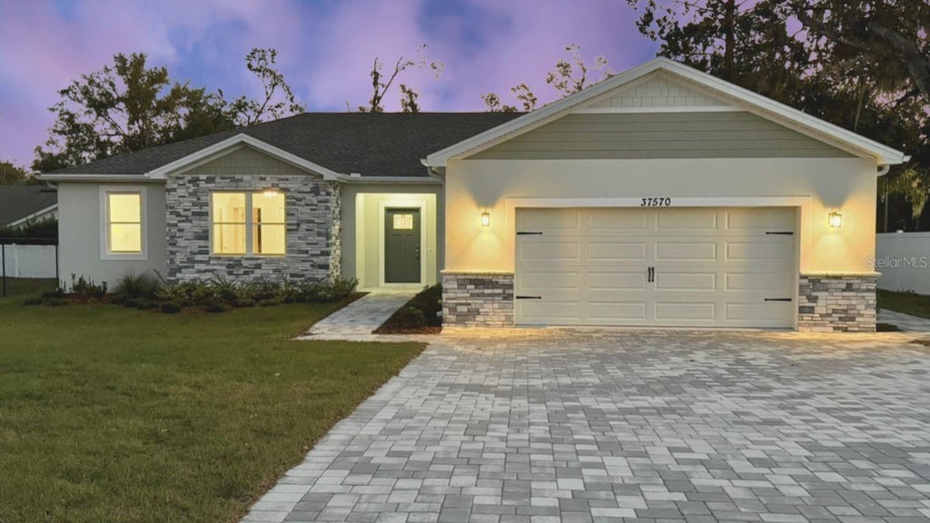 view of front of home with a lawn and a garage