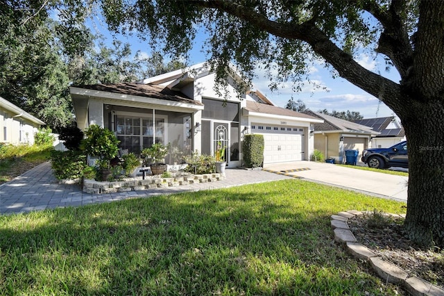 view of front of property with a front yard and a garage