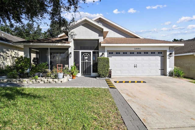 view of front of house with a front yard and a garage