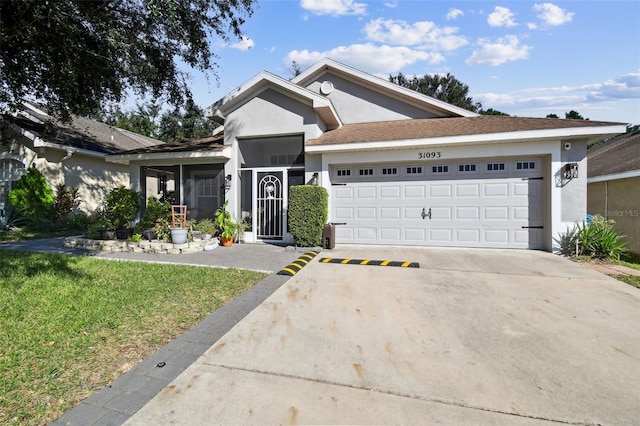 view of front of property with a front lawn and a garage