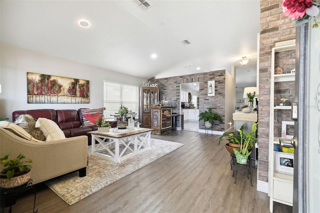 living room with vaulted ceiling and hardwood / wood-style floors