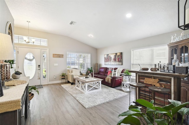 living room with lofted ceiling and light hardwood / wood-style flooring