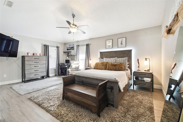 bedroom with light hardwood / wood-style flooring and ceiling fan