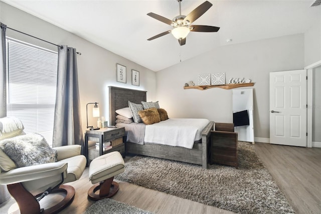 bedroom featuring ceiling fan, wood-type flooring, and vaulted ceiling