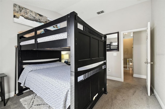 carpeted bedroom featuring lofted ceiling