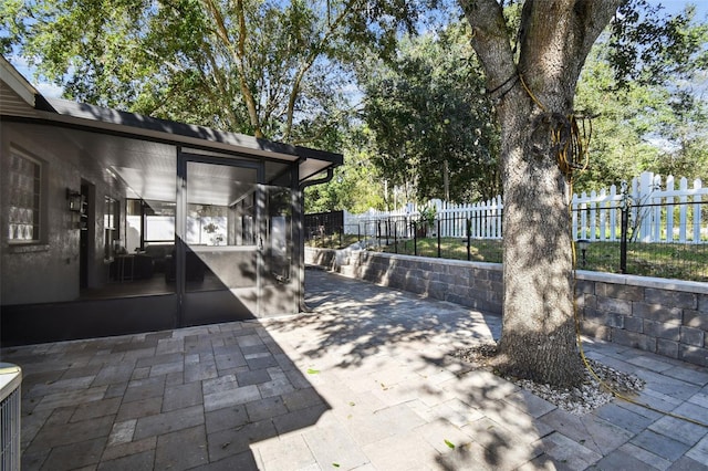 view of patio featuring a sunroom