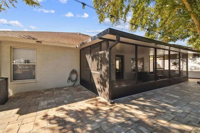 exterior space featuring a sunroom and a patio area