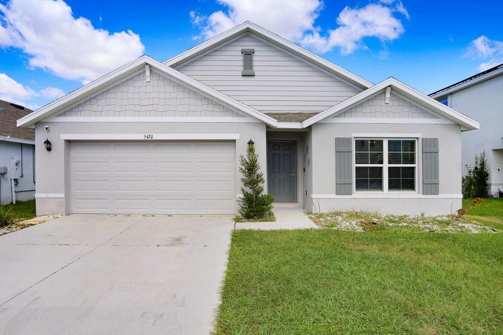 view of front facade with a front yard and a garage