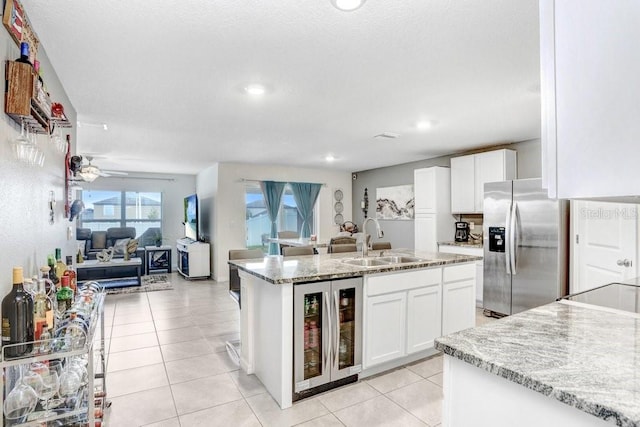 kitchen with sink, wine cooler, white cabinetry, and stainless steel fridge with ice dispenser