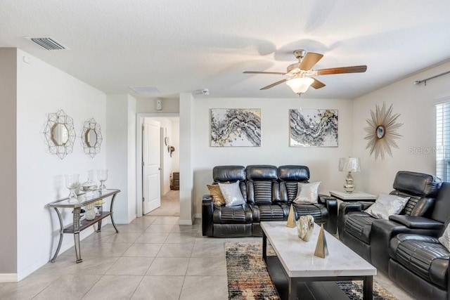 tiled living room featuring a textured ceiling and ceiling fan