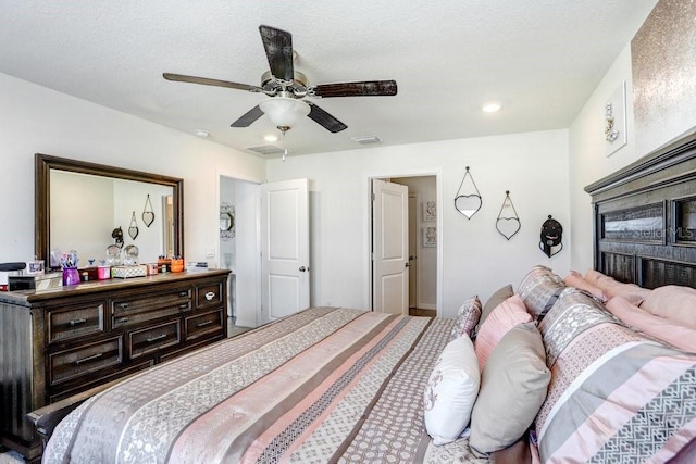 bedroom with a textured ceiling and ceiling fan