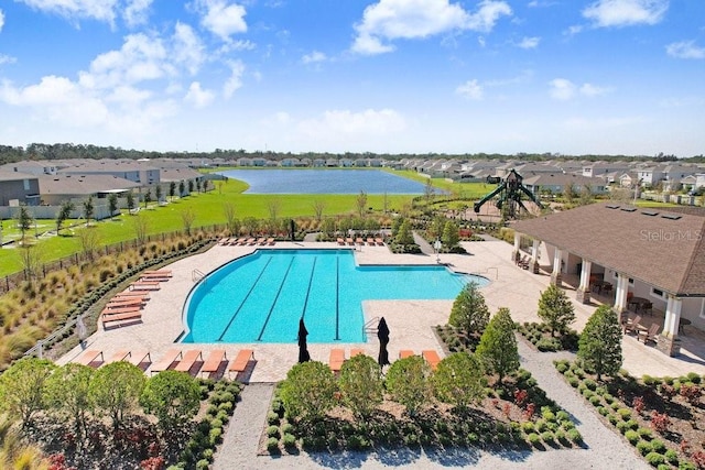 view of swimming pool with a patio and a water view