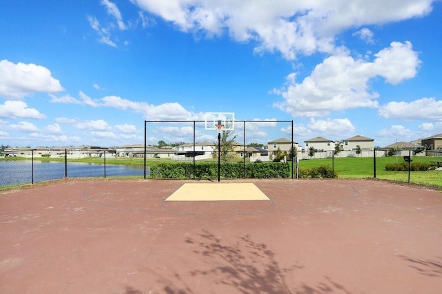 view of sport court with a water view