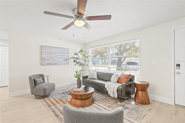 living room featuring light hardwood / wood-style floors and ceiling fan