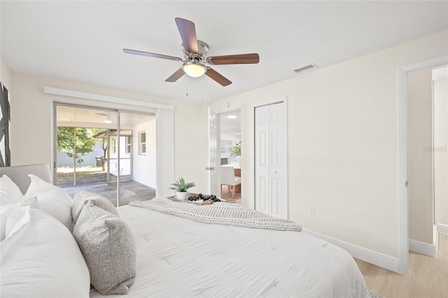 bedroom with access to exterior, light wood-type flooring, and ceiling fan