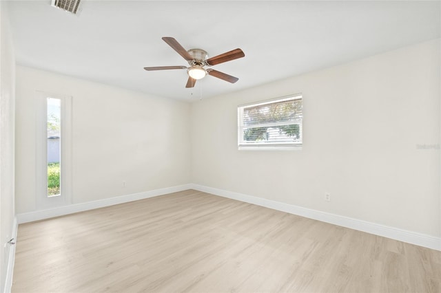 spare room featuring ceiling fan, light hardwood / wood-style flooring, and plenty of natural light