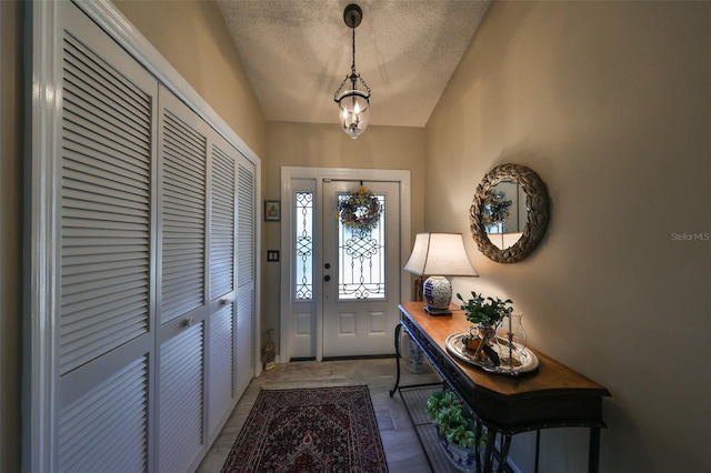 entrance foyer with a textured ceiling