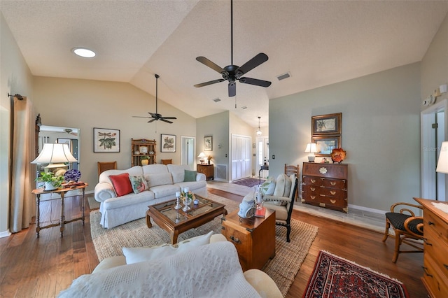 living room featuring a textured ceiling, ceiling fan, dark hardwood / wood-style flooring, and lofted ceiling