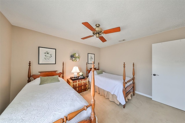 carpeted bedroom with a textured ceiling and ceiling fan