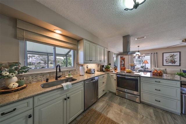 kitchen featuring sink, decorative backsplash, decorative light fixtures, island exhaust hood, and stainless steel appliances