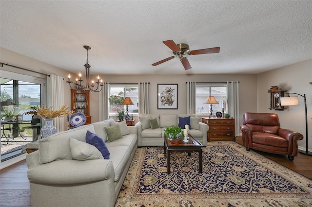 living room featuring wood-type flooring, a textured ceiling, and a wealth of natural light