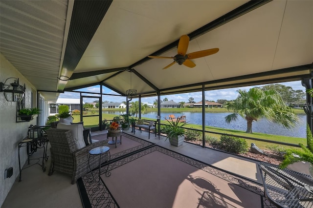 sunroom featuring ceiling fan, plenty of natural light, and a water view