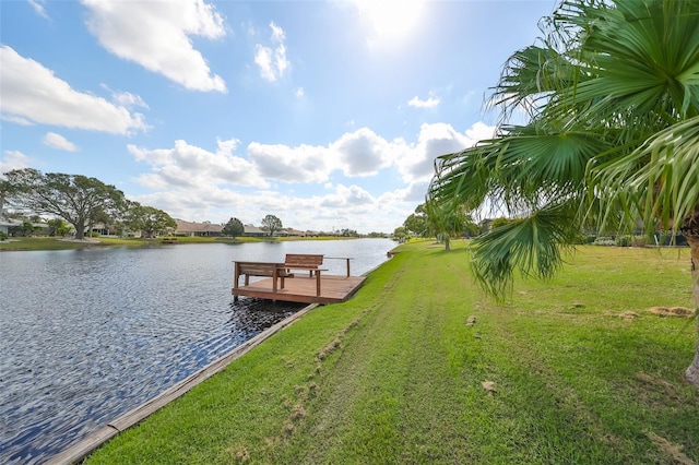 dock area with a yard and a water view