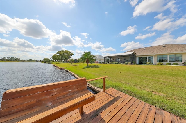 dock area featuring a lawn and a water view