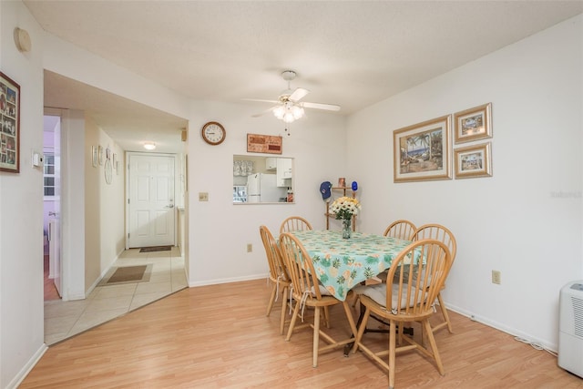 dining room featuring light hardwood / wood-style floors, a textured ceiling, and ceiling fan