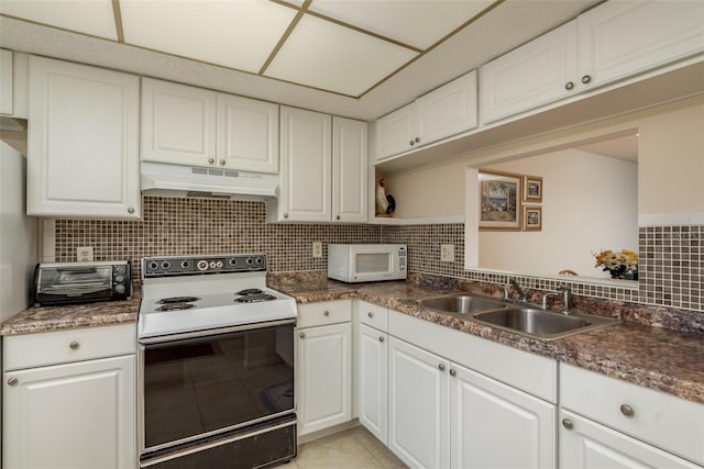 kitchen with white appliances, backsplash, sink, and white cabinets