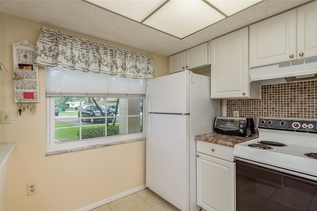 kitchen featuring white appliances, decorative backsplash, light tile patterned flooring, and white cabinets