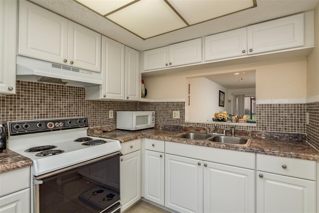 kitchen with sink, white cabinets, decorative backsplash, and white appliances