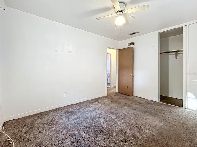 unfurnished bedroom featuring a closet, dark carpet, and ceiling fan