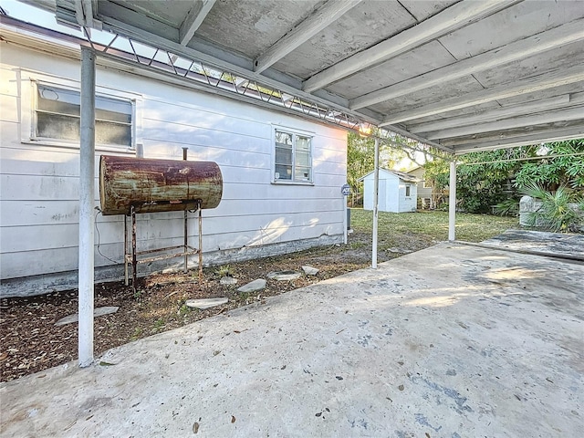 view of patio / terrace featuring a storage unit