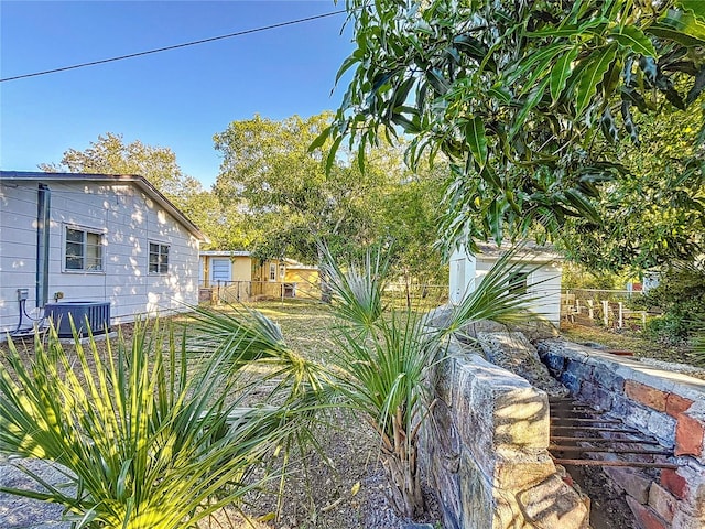 view of yard with central AC unit