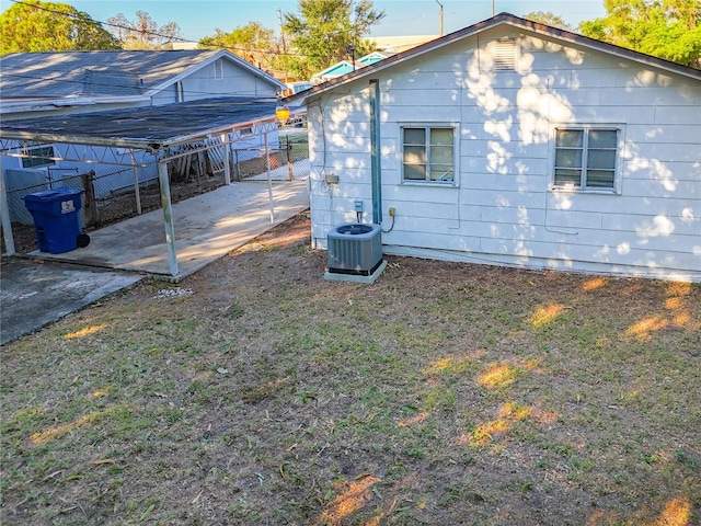 rear view of property featuring central air condition unit and a patio area