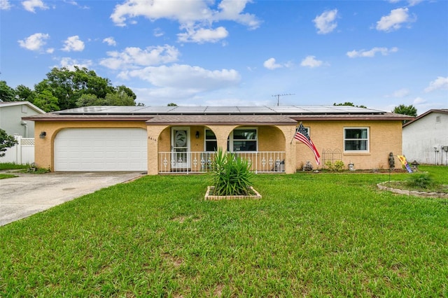 single story home featuring covered porch, a garage, a front lawn, and solar panels