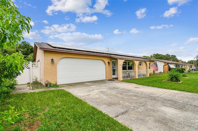 single story home featuring a garage, a front lawn, solar panels, and a porch