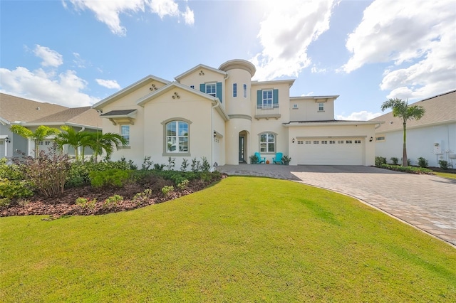 mediterranean / spanish house featuring a front yard and a garage