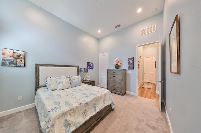 bedroom featuring a towering ceiling and carpet floors