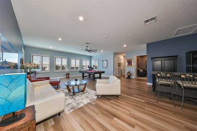 living room with hardwood / wood-style flooring and ceiling fan