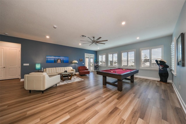 recreation room with ceiling fan, pool table, a textured ceiling, and light wood-type flooring