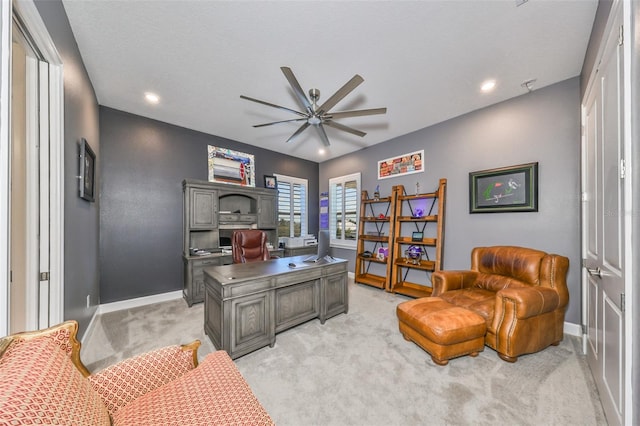 carpeted office featuring ceiling fan