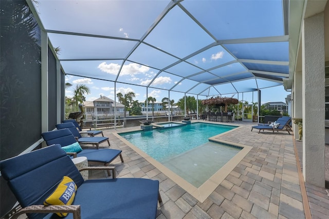 view of pool with a patio area and glass enclosure